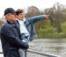 older-man-holding-his-grandson-park-near-lake (1) (1)